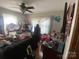 View of cluttered bedroom showing a bed with multiple windows at 4303 Grier St, Gastonia, NC 28056