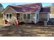 Charming single-story home with a cozy porch and beautiful red metal roof at 4303 Grier St, Gastonia, NC 28056