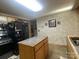 Kitchen view showcasing the refrigerator, range, island, and decorative walls at 4303 Grier St, Gastonia, NC 28056
