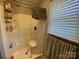 Clean shower with built-in shelving and a convenient shower chair at 4303 Grier St, Gastonia, NC 28056