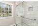 Modern bathroom featuring a glass-enclosed shower, stylish tile work, and bright natural light at 608 Red Hawk Way, Clover, SC 29710