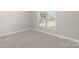 Carpeted bedroom with a window allowing natural light, creating a comfortable and inviting atmosphere at 608 Red Hawk Way, Clover, SC 29710
