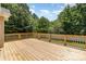 Large wooden deck, ideal for relaxation and enjoying the serene, tree-filled backyard at 608 Red Hawk Way, Clover, SC 29710
