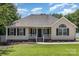 Charming single-story home with a manicured lawn, a welcoming porch, and black shutters at 608 Red Hawk Way, Clover, SC 29710