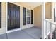 Welcoming front porch with a black door, adjacent window, and neutral siding at 608 Red Hawk Way, Clover, SC 29710
