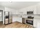 Modern kitchen with stainless steel appliances, white cabinetry, and subway tile backsplash at 608 Red Hawk Way, Clover, SC 29710