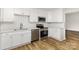 Bright kitchen featuring white cabinets, stainless steel appliances, and wood-look floors at 608 Red Hawk Way, Clover, SC 29710