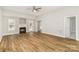 Bright living room with hardwood floors, a ceiling fan, and a cozy fireplace at 608 Red Hawk Way, Clover, SC 29710