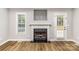 Living room featuring a fireplace, hardwood floors, and natural light at 608 Red Hawk Way, Clover, SC 29710