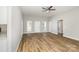 Spacious living room with wood floors, neutral walls, bright windows, and a ceiling fan at 608 Red Hawk Way, Clover, SC 29710
