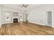Bright living room featuring hardwood floors, a ceiling fan, and a cozy fireplace at 608 Red Hawk Way, Clover, SC 29710
