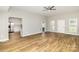 Open-concept living area showcasing hardwood floors and seamless kitchen access at 608 Red Hawk Way, Clover, SC 29710