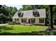 Charming home with dormer windows, a front porch, and a lovely yard surrounded by lush trees at 7648 Forest Oak Dr, Denver, NC 28037