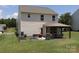 This large backyard is equipped with a gazebo with patio furniture, garden beds, and a well-manicured lawn at 864 Pointe Andrews Dr, Concord, NC 28025