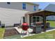 An outdoor patio area features a grill and dining set, plus garden beds for growing fruits and vegetables at 864 Pointe Andrews Dr, Concord, NC 28025