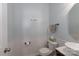 Charming powder room with a pedestal sink, white wainscoting, and decorative 'Le Bain' wall art at 864 Pointe Andrews Dr, Concord, NC 28025