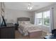 Inviting bedroom with large window, neutral color scheme, and ceiling fan at 864 Pointe Andrews Dr, Concord, NC 28025