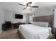 Comfortable bedroom featuring a plush bed, flat screen tv, and neutral decor with a ceiling fan at 864 Pointe Andrews Dr, Concord, NC 28025