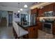 The updated kitchen features granite countertops, stainless steel appliances, and an island with barstool seating at 864 Pointe Andrews Dr, Concord, NC 28025