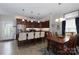 Modern kitchen with granite countertops, stainless steel appliances, central island, and eat-in dining area at 864 Pointe Andrews Dr, Concord, NC 28025