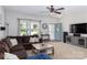 Cozy living room with plush sectional couch, bright windows, and stylish furnishings at 864 Pointe Andrews Dr, Concord, NC 28025