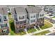 A beautiful aerial perspective of multi-story townhomes showing well-maintained lawns and coordinated architecture at 9921 Oaklawn Nw Blvd, Huntersville, NC 28078