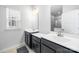 Modern bathroom featuring double sinks, dark cabinetry, and a large mirror at 9921 Oaklawn Nw Blvd, Huntersville, NC 28078