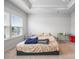 A sunlit bedroom showcases large windows, neutral decor, and soft carpet at 9921 Oaklawn Nw Blvd, Huntersville, NC 28078