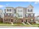Inviting townhouse featuring brick accents, complementary siding, and well-maintained landscaping at 9921 Oaklawn Nw Blvd, Huntersville, NC 28078