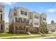 Charming townhome showcasing brick accents, complementary siding, and a well-manicured lawn at 9921 Oaklawn Nw Blvd, Huntersville, NC 28078
