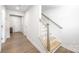 Hallway with stairs and laminate floors at 9921 Oaklawn Nw Blvd, Huntersville, NC 28078
