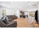 A generously sized living area with wood flooring, ample natural light, and a view of the kitchen at 9921 Oaklawn Nw Blvd, Huntersville, NC 28078