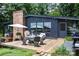 Charming backyard deck featuring a patio set, umbrella, and grill, perfect for outdoor entertaining at 109 Joe Teague Rd, Hickory, NC 28601
