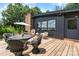 Well-appointed backyard deck area featuring an outdoor table, chairs, umbrella, and grill at 109 Joe Teague Rd, Hickory, NC 28601