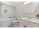 Bright bathroom featuring a tub, toilet, and vanity with natural light at 109 Joe Teague Rd, Hickory, NC 28601