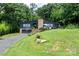 Beautifully landscaped home with a well-manicured lawn and brick chimney; a basketball hoop sits near the garage at 109 Joe Teague Rd, Hickory, NC 28601