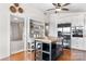 Bright kitchen featuring stainless steel appliances, white cabinetry, an island, and hardwood floors at 109 Joe Teague Rd, Hickory, NC 28601