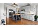Bright kitchen featuring stainless steel appliances, white cabinetry, an island, and hardwood floors at 109 Joe Teague Rd, Hickory, NC 28601