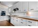 Bright kitchen featuring updated appliances, white cabinetry, tile backsplash and hardwood floors at 109 Joe Teague Rd, Hickory, NC 28601
