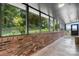 Enclosed brick patio with multiple windows provides beautiful views of lush foliage and greenery at 109 Joe Teague Rd, Hickory, NC 28601