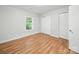 Bedroom featuring hardwood floors, a window with blinds, and closet at 116 Honeywood Ave, Charlotte, NC 28216