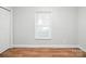 Cozy bedroom with hardwood floors, a single window, and freshly painted walls at 116 Honeywood Ave, Charlotte, NC 28216