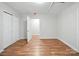 Bright bedroom with two closets, hardwood floors, and a neutral color scheme at 116 Honeywood Ave, Charlotte, NC 28216