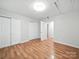 Large bedroom with hardwood floors, closets, and a neutral color scheme at 116 Honeywood Ave, Charlotte, NC 28216