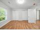 Spacious bedroom with hardwood floors, natural light, and a double closet at 116 Honeywood Ave, Charlotte, NC 28216