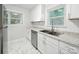 Updated kitchen featuring sleek stainless dishwasher and ample counter space by window at 116 Honeywood Ave, Charlotte, NC 28216