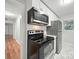 Bright kitchen with modern stainless steel appliances and ample white cabinetry at 116 Honeywood Ave, Charlotte, NC 28216