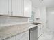Bright kitchen showcasing new countertops, stainless dishwasher, and white subway tile backsplash at 116 Honeywood Ave, Charlotte, NC 28216