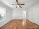 Spacious living room with hardwood flooring, lots of natural light, and a ceiling fan at 116 Honeywood Ave, Charlotte, NC 28216