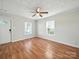 Well-lit living room boasts original hardwood flooring and ample natural light through two windows at 116 Honeywood Ave, Charlotte, NC 28216